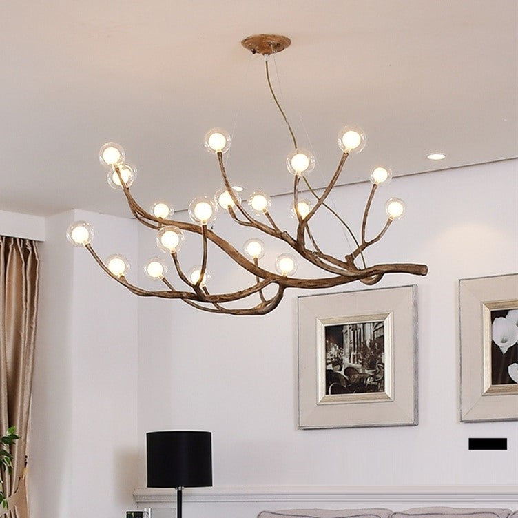 Lustre branche d’arbre orné de boules de verre